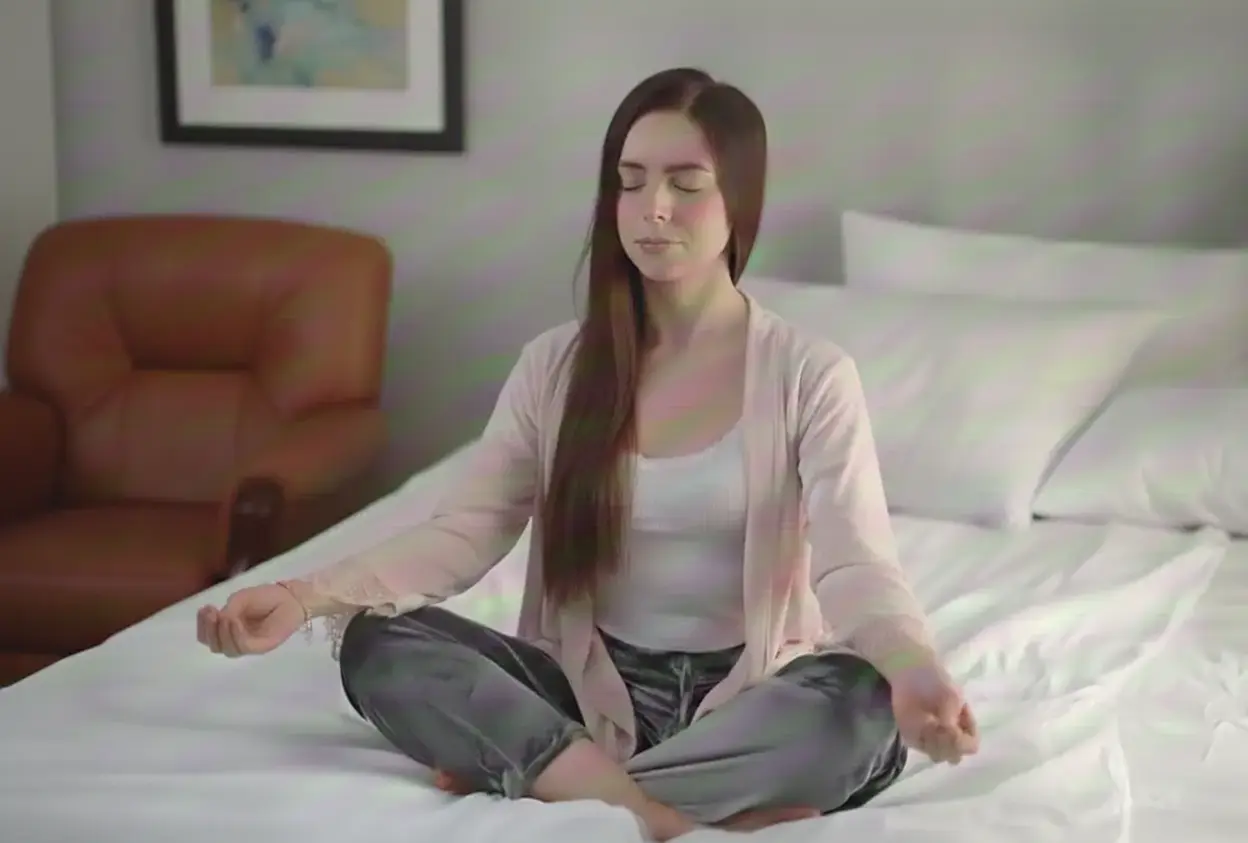 An adult person doing a breathing exercise in a cozy room in the evening