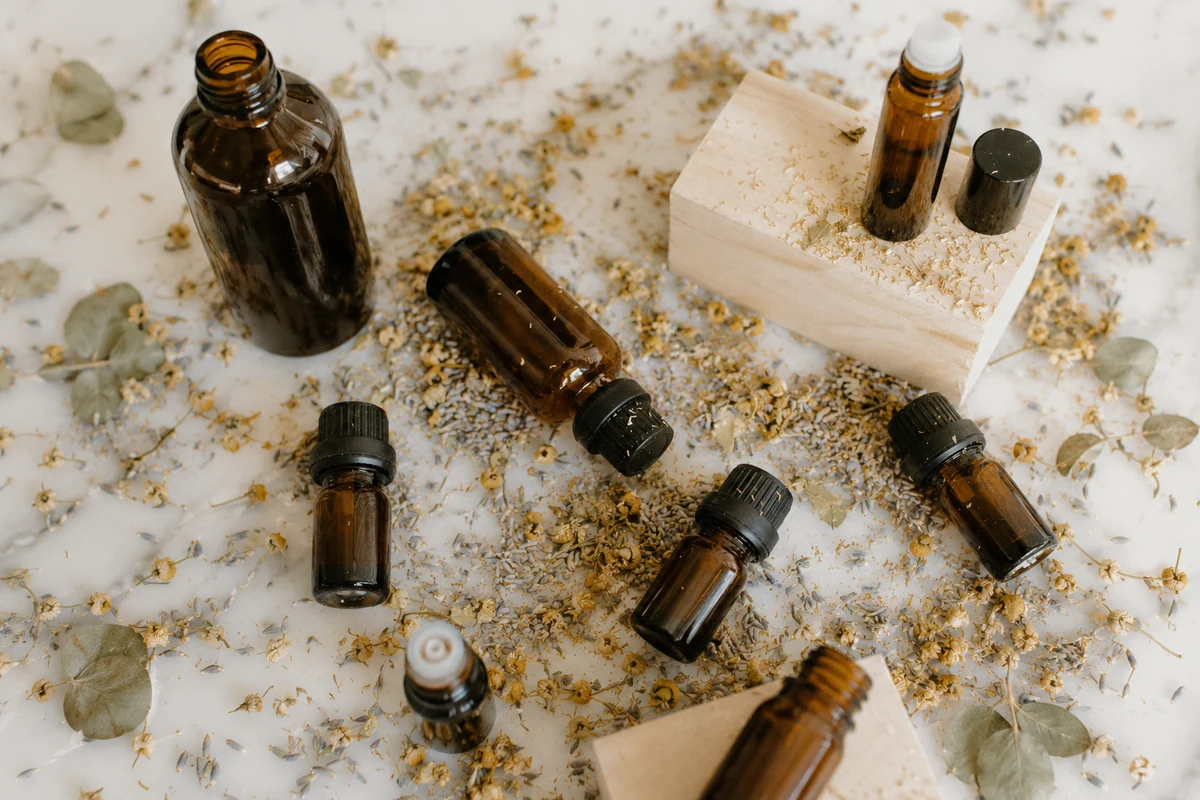 Amber bottles and dried plants as an image of natural fragrance in cosmetics