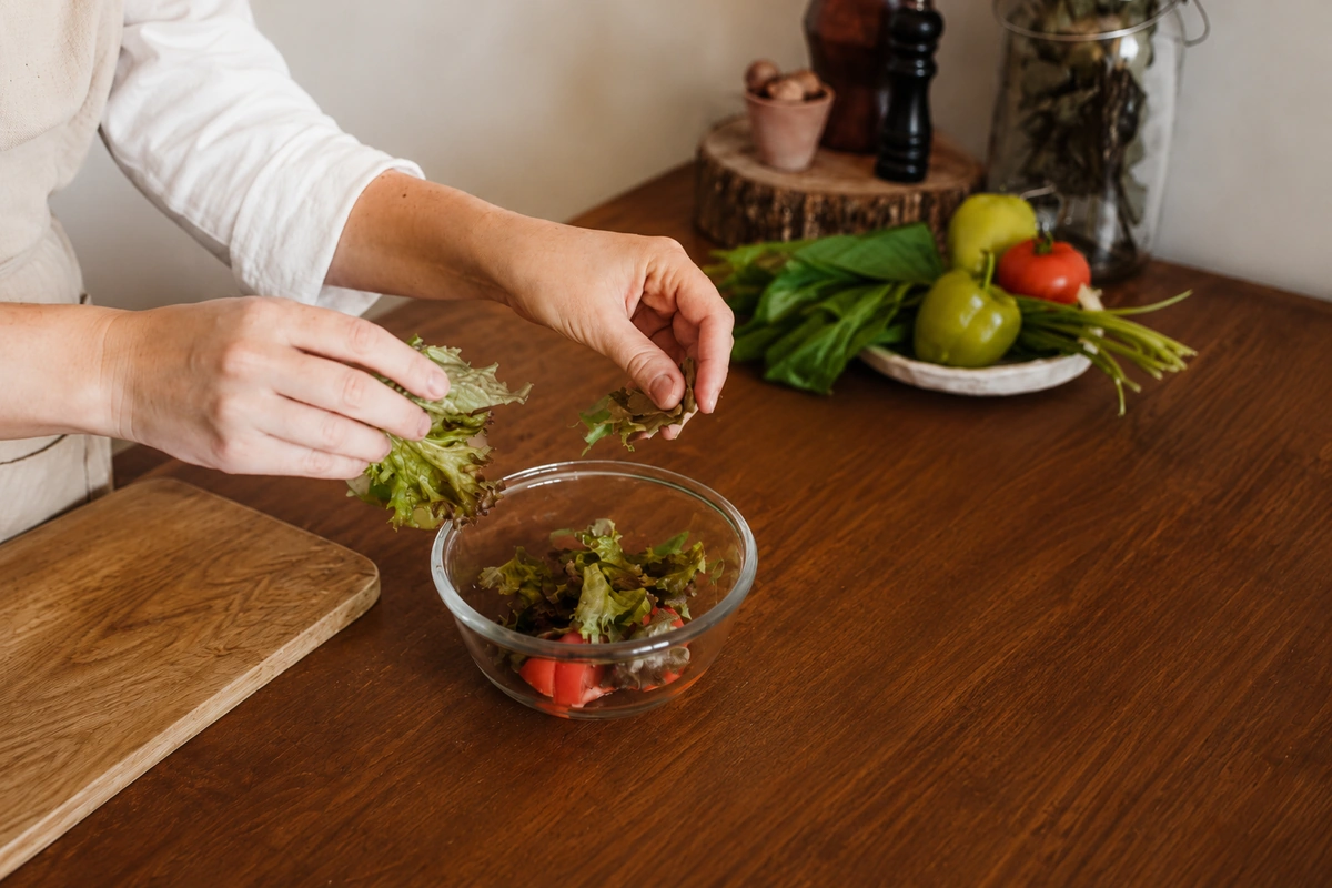 Food and skin health. A woman making a salad.